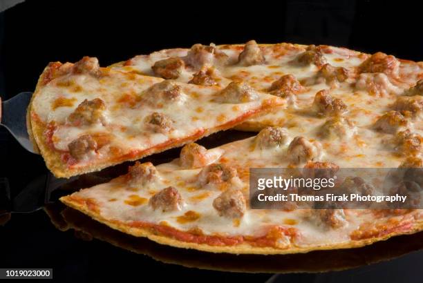 sausage and cheese thin crust pizza -  firak stock pictures, royalty-free photos & images