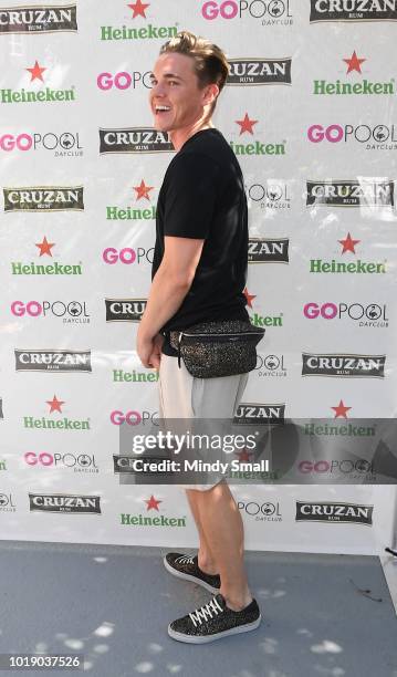 Recording artist Jesse McCartney, Saint Laurent fanny pack detail, arrives at The Flamingo Go Pool on August 18, 2018 in Las Vegas, Nevada.