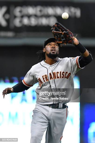 Alen Hanson of the San Francisco Giants catches a fly ball in the fifth inning against the Cincinnati Reds at Great American Ball Park on August 18,...
