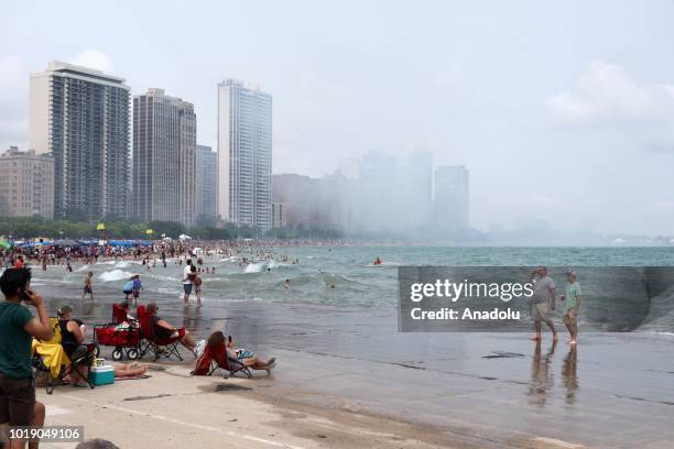 People gather as aircrafts perform over Lake Michigan during the 60th Chicago Air and Water Show, in Chicago, United States on August 18, 2018....