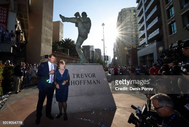 National Baseball Hall of Fame pitcher Trevor Hoffman poses for a photo with his mother Mikki Hoffman next to his statue before a baseball game...