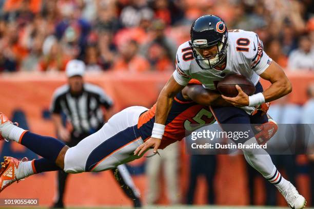 Linebacker Bradley Chubb of the Denver Broncos hits quarterback Mitchell Trubisky of the Chicago Bears in the end zone for a first quarter safety...