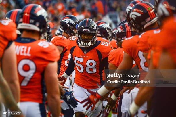 Linebacker Von Miller of the Denver Broncos runs onto the field during player introductions an NFL preseason game against the Chicago Bears at...