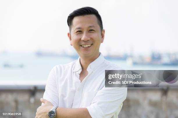confident mid adult asian businessman - singaporean man stock pictures, royalty-free photos & images