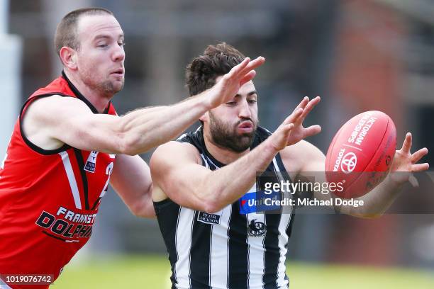 Alex Fasolo of the Magpies from Jake Batchelor of Frankston during the round 20 VFL match between Collingwood and Frankston at Victoria Park on...