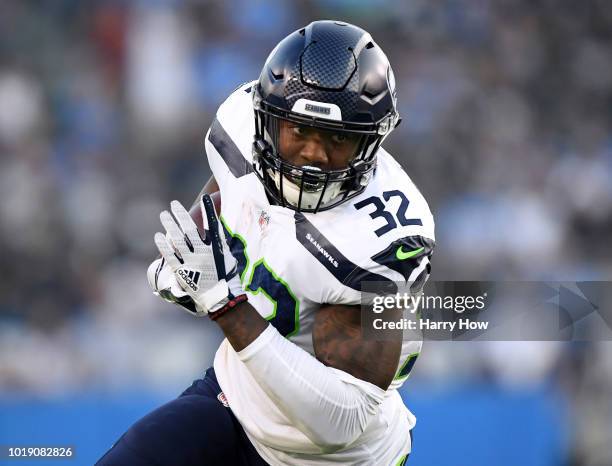 Chris Carson of the Seattle Seahawks turns as he carries the ball during the first quarter against the Los Angeles Chargers during a presseason game...