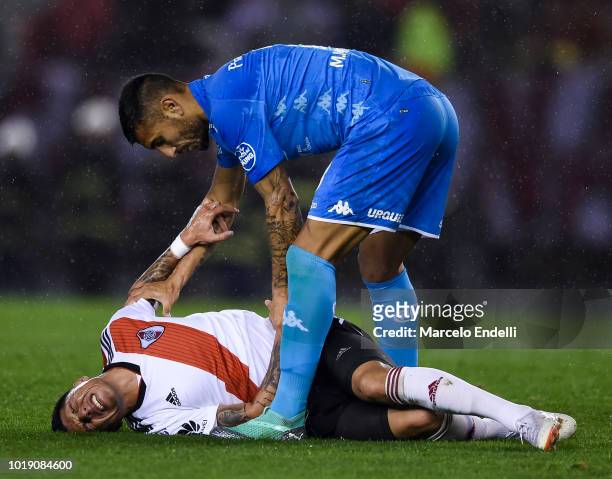 Miguel Martinez of Belgrano attend Enzo Perez of River Plate during a match between River Plate and Belgrano as part of Superliga Argentina 2018/19...