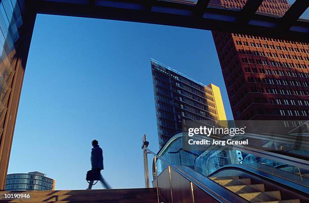 businessman leaving railway station (digital enhancement) - postdamer platz stock-fotos und bilder