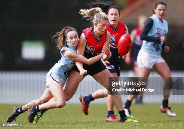 Georgia Gee of the Blues tackles Genevieve Lawson-Tavan of Darebin during the VFLW round 15 match between Darebin and Carlton at Bill Lawry Oval on...