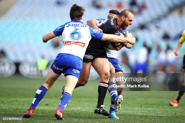 Simon Mannering of the Warriors is tackled during the round 23 NRL match between the Canterbury Bulldogs and the New Zealand Warriors at ANZ Stadium...