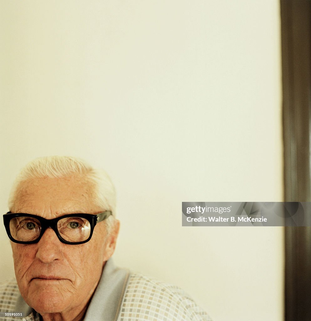 Mature man wearing black rimmed glasses, portrait