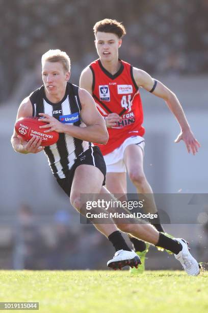 Josh Smith of the Magpies runs with the ball during the round 20 VFL match between Collingwood and Frankston at Victoria Park on August 19, 2018 in...