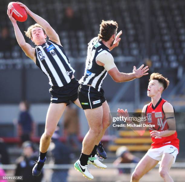 Tyler Brown of the Magpies marks the ball against Thomas Kelly of Frankston during the round 20 VFL match between Collingwood and Frankston at...