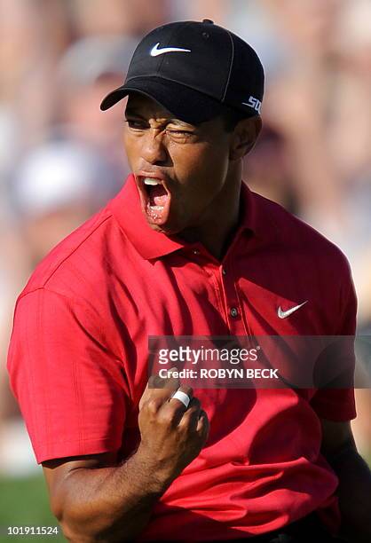 Tiger Woods of the US celebrates his birdie putt on the 18th hole in the fourth round of the 108th U.S. Open golf tournament at Torrey Pines Golf...