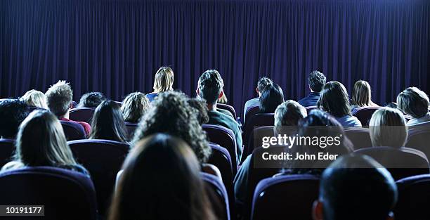 crowd of people in movie theater, rear view - cinema audience imagens e fotografias de stock