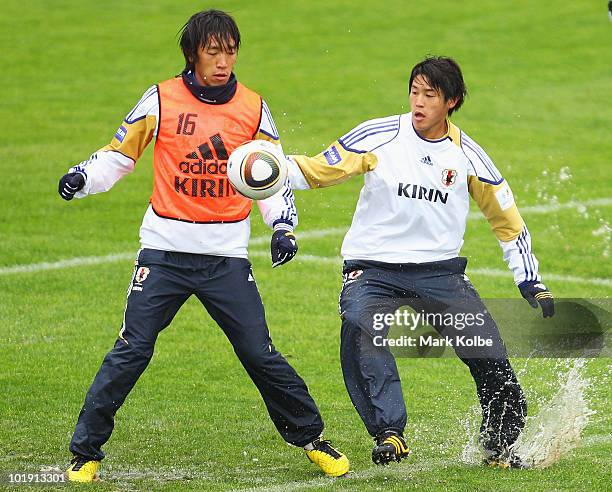 Shunsuke Nakamura and Atsuto Uchida compete for the ball during a Japan training session at Outeniqua Stadium on June 9, 2010 in George, South Africa.