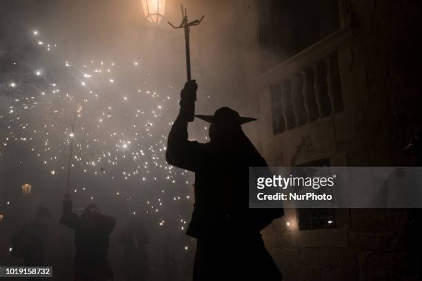 Devil goes amidst the pyrotechnics during the celebration of Sant Roc Festival in Barcelona on 18 August, 2018. Correfocs, an old Catalan tradition...