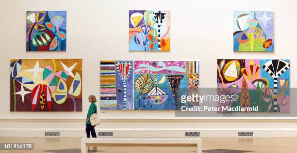 Visitor looks at paintings hanging at The Royal Academy Summer Exhibition on June 9, 2010 in London, England. The RA Summer exhibition is the world's...