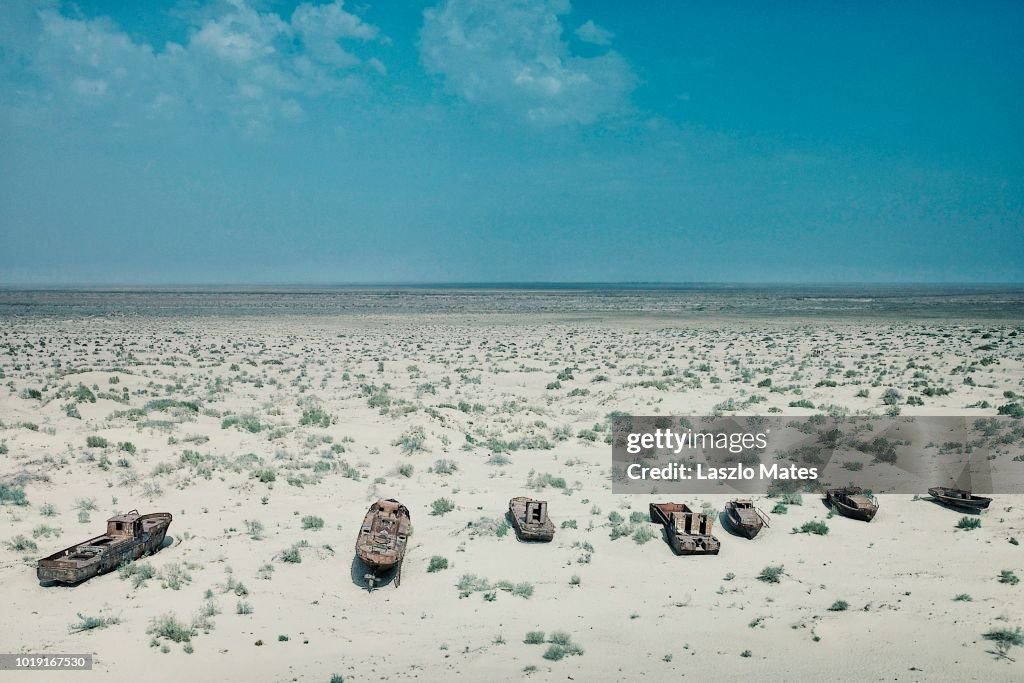 Moynaq / Uzbekistan - MAY 5 2010: abandoned boats rusting away in the sand at the once blooming sea port