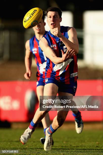 Xavier O'Neill of Oakleigh Chargers handballs during the TAC Cup round 15 match between Oakleigh Chargers and Sandringham Dragons at Avalon Airport...