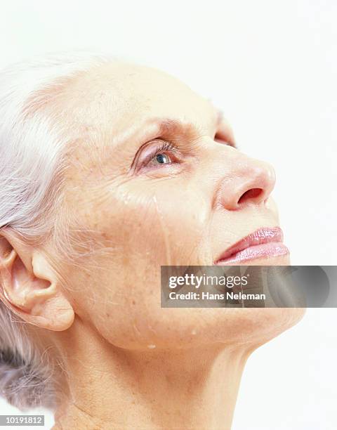 mature woman crying, profile, close-up - teardrop stockfoto's en -beelden
