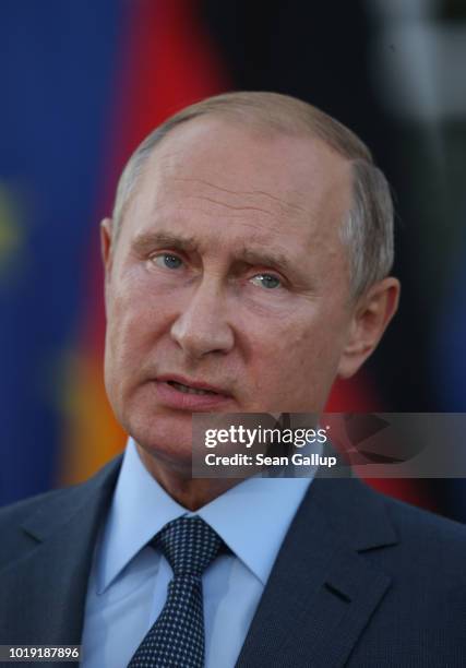 Russian President Vladimir Putin and German Chancellor Angela Merkel give statements to the media prior to talks at Schloss Meseberg palace, the...