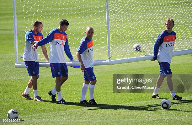 Johnny Heitinga, Robin Van Persie, Demy De Zeeuw and Dirk Kuyt of the Netherlands move the goal during a training session at the Wits Stadium on June...