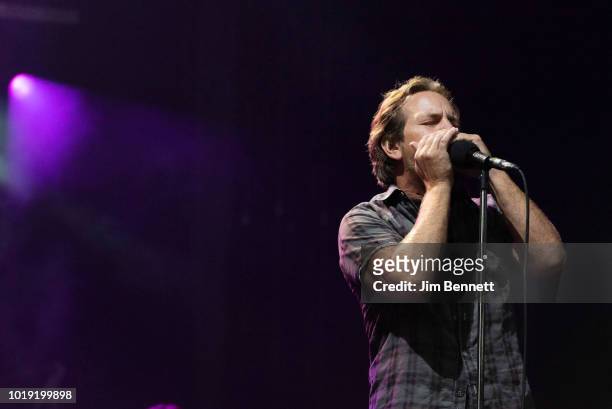 Singer and guitarist Eddie Vedder of Pearl Jam plays harmonica live on stage at Safeco Field on August 10, 2018 in Seattle, Washington.