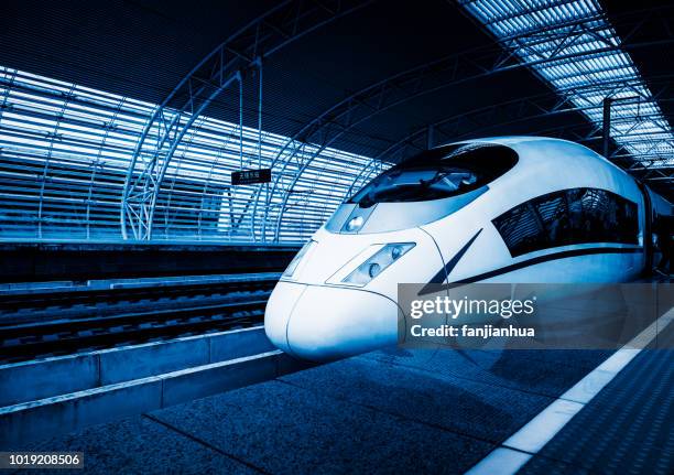 view of high-speed train arriving/leaving - bullet train stock-fotos und bilder