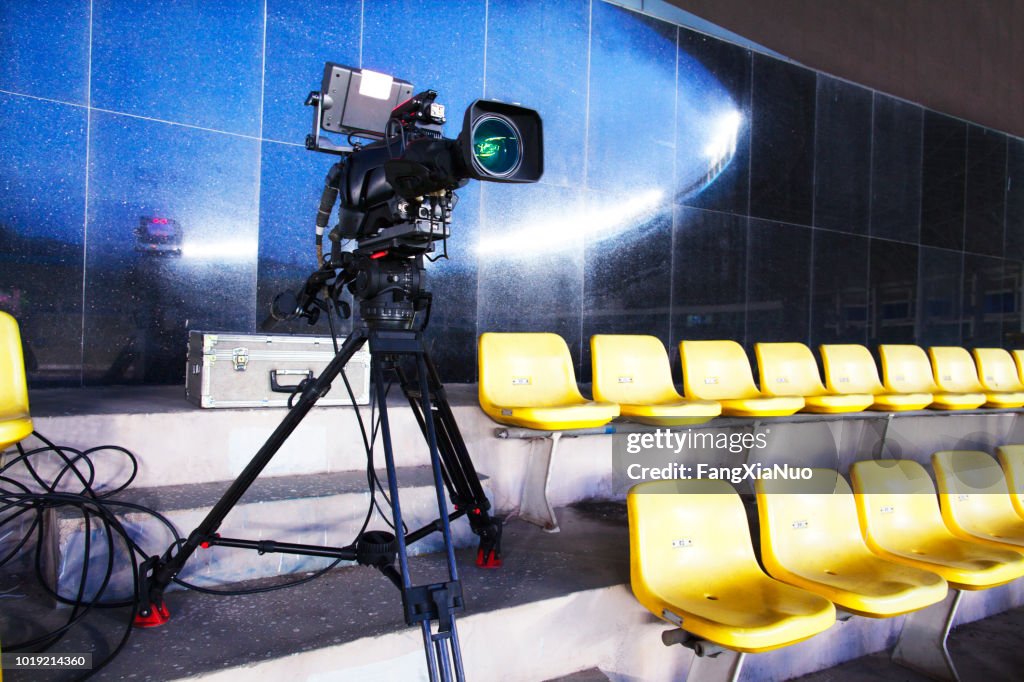 Professional TV camera filming event in a stadium