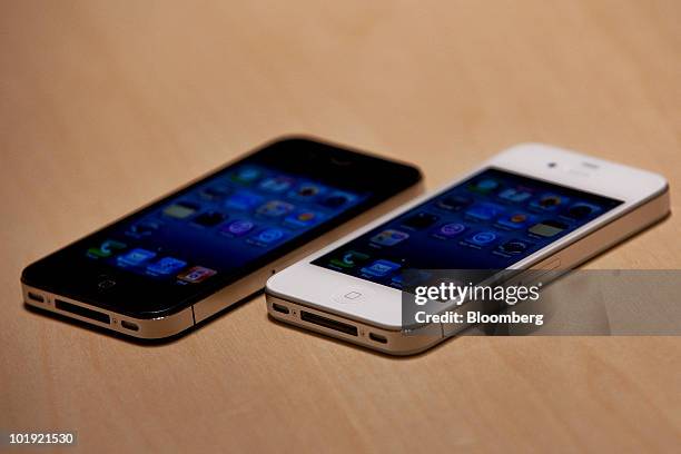 Models of Apple Inc.'s iPhone 4 are displayed for a photo at the Apple Worldwide Developers Conference in San Francisco, California, U.S., on Monday,...