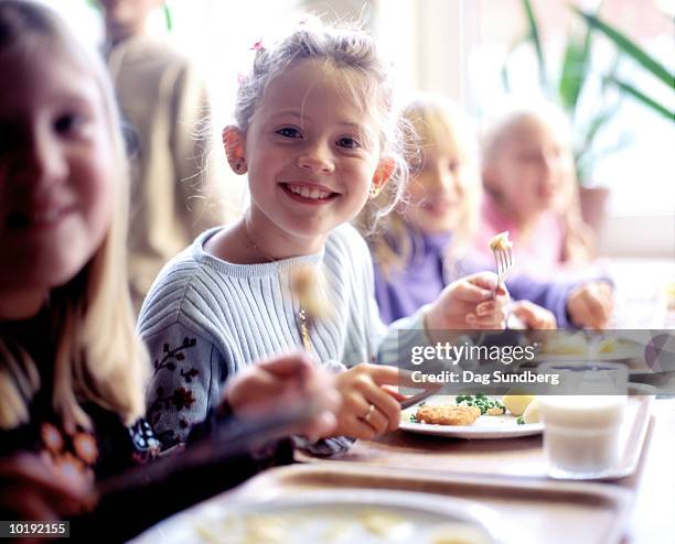 children (6-8) eating school dinner, portrait - dag 7 stock pictures, royalty-free photos & images
