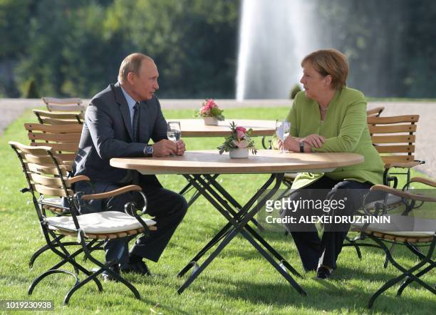 German Chancellor Angela Merkel meets with Russian President Vladimir Putin on August 18, 2018 at Schloss Meseberg castle in Meseberg, northeastern...