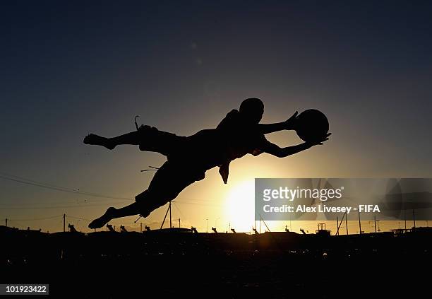 Local kids play football at the Kayelitsha Township near Cape Town on June 9, 2010 in Cape Town, South Africa.