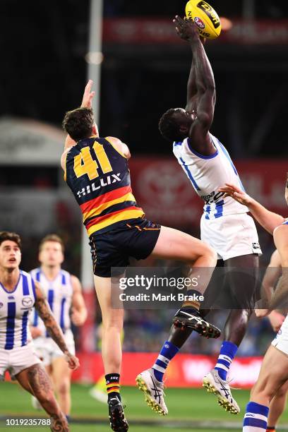 Majak Daw of the Kangaroos marks in front of Mitch McGovern of the Adelaide Crows during the round 22 AFL match between the Adelaide Crows and North...