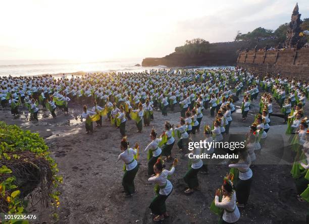 Total of 1800 dancers perform the Rejang Sandat Dance Ratu Segara, in the area of Tanah Lot Temple, Tabanan Regency, Bali, on August 18, 2018. For...