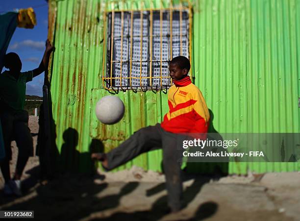 Local kids play football at the Kayelitsha Township near Cape Town on June 9, 2010 in Cape Town, South Africa.