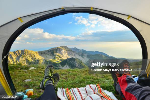 tent view of mountain range with hiking boot in the foreground - pirin mountains stockfoto's en -beelden