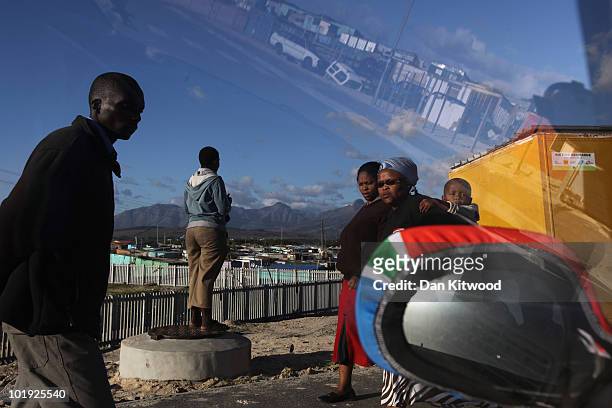 Residents walk through the Kayelitsha Township on June 9, 2010 in Cape Town, South Africa. The first World Cup ever held in Africa is due to begin in...
