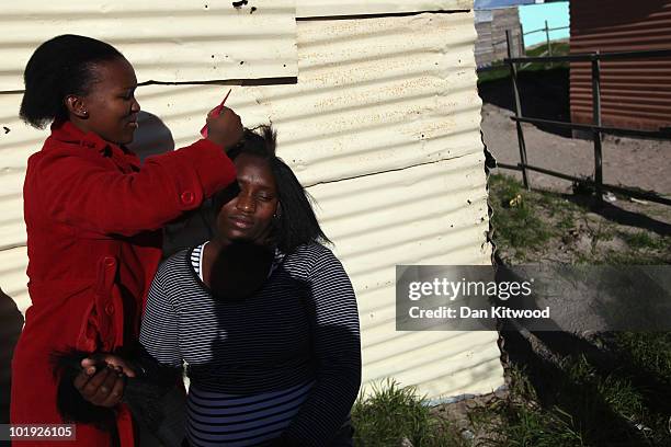 Woman has her hair done in the Kayelitsha Township on June 9, 2010 in Cape Town, South Africa. The first World Cup ever held in Africa is due to...