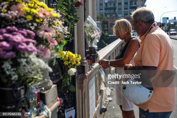 People light candles for the victims of the Morandi Bridge collapse among other tributes on a bridge opposite on August 19, 2018 in Genoa, Italy. 43...