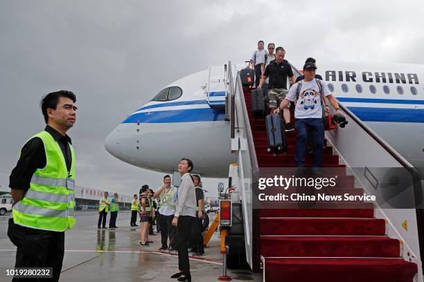 Passengers get off the Airbus A350-900 of Air China after its maiden flight at Shanghai Hongqiao International Airport on August 14, 2018 in...