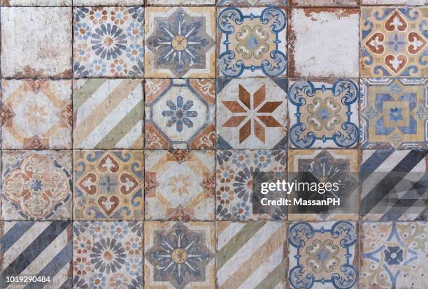 different ceramic tiles with mediterranean style patterns in orange and blue on a wall - marsala sicily fotografías e imágenes de stock