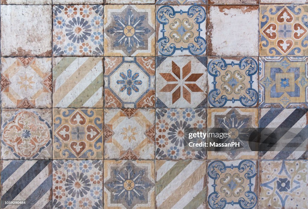 Different ceramic tiles with mediterranean style patterns in orange and blue on a wall
