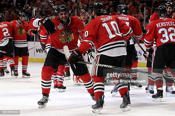 Dustin Byfuglien and Patrick Sharp of the Chicago Blackhawks celebrate after defeating the Philadelphia Flyers 7-4 in Game Five of the 2010 NHL...