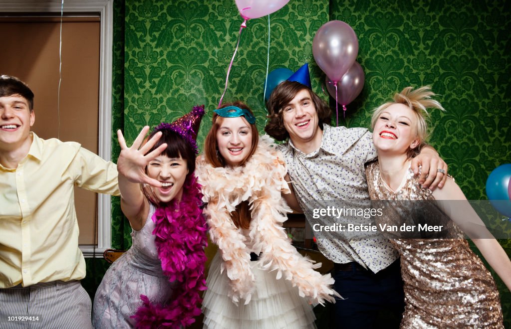 Group of young people dancing at party.