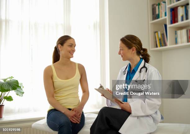 patient talking to female doctor. - young women talking stock pictures, royalty-free photos & images