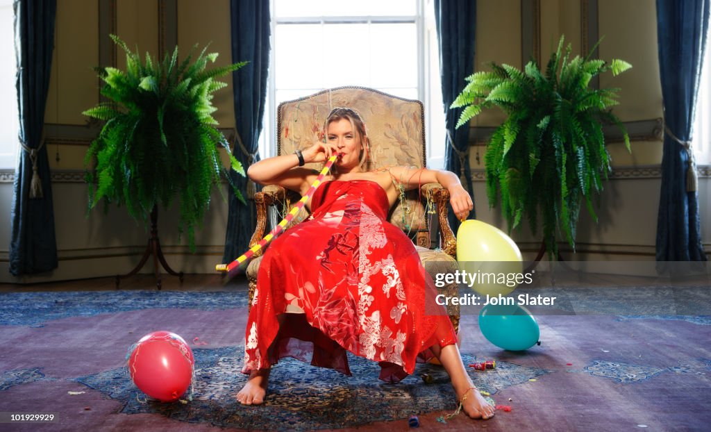 girl slumped in chair with party gimicks