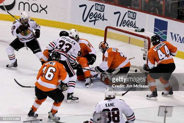 Dustin Byfuglien of the Chicago Blackhawks scores a power play goal in the first period against Michael Leighton of the Philadelphia Flyers in Game...