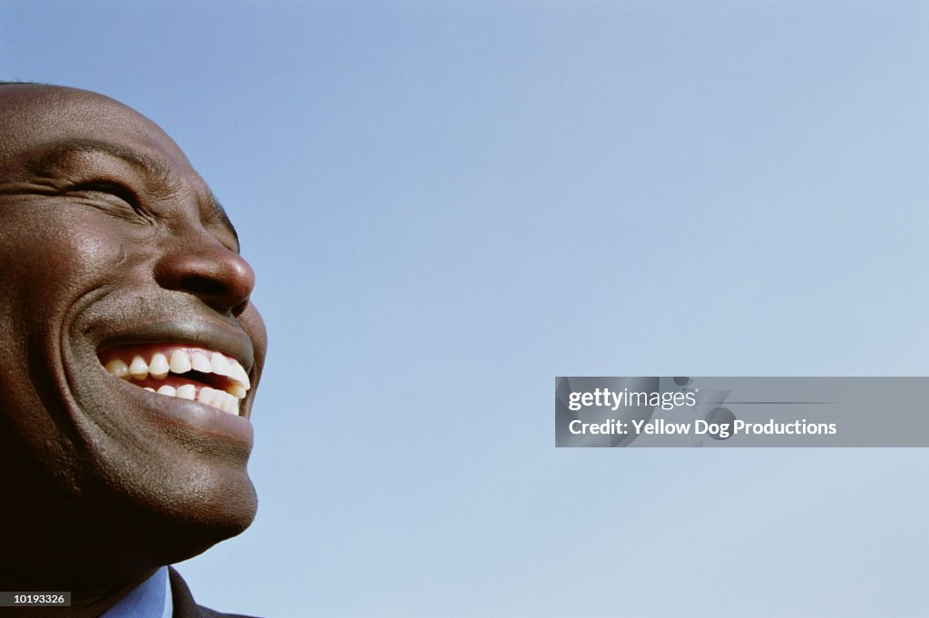 Man smiling, side view, close up